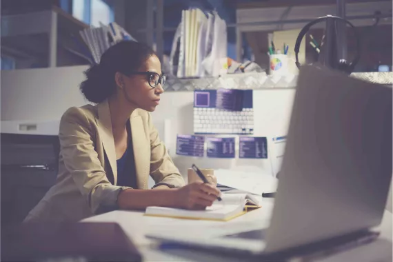 Woman at desk making notes