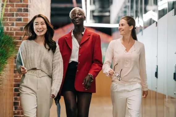 Three business woman confidently walking in the office